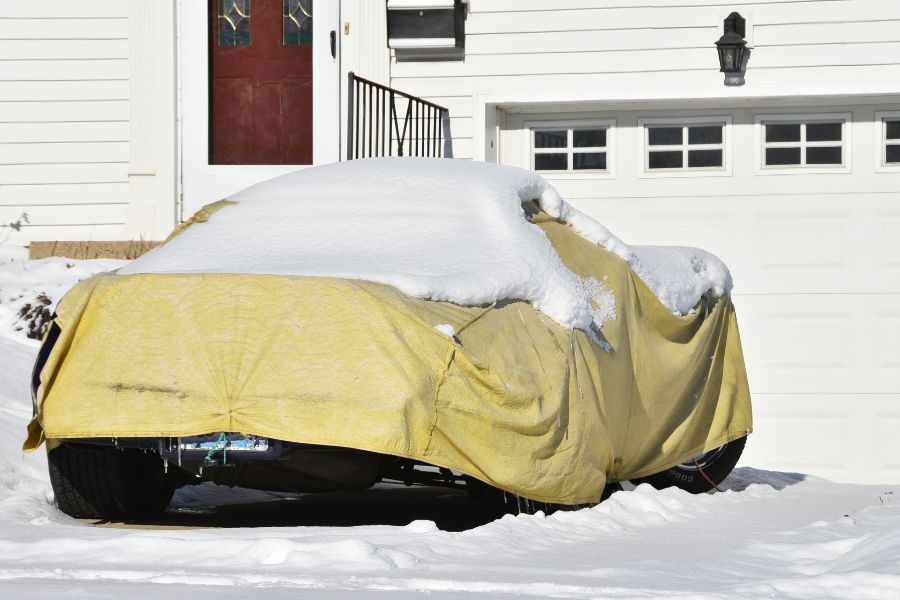 Car with yellow cover in winter