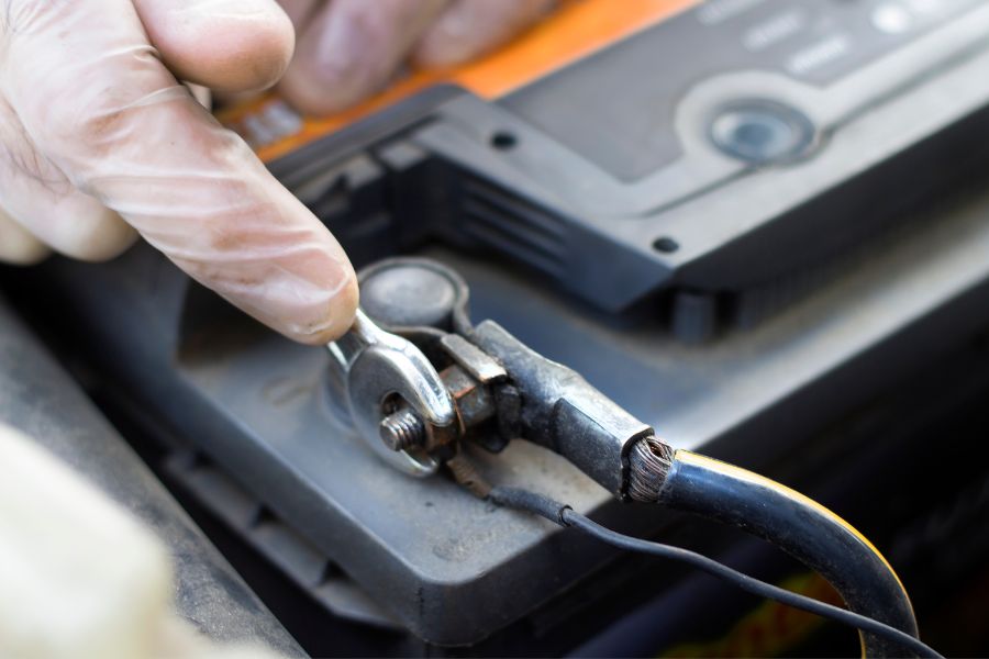 Hand disconnecting the car battery